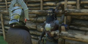 Das Bild zeigt eine Szene aus einem Spiel, in der zwei Charaktere miteinander interagieren. Einer der Charaktere trägt eine auffällige, stilisierte Rüstung und einen Helm, während der andere einen Bart hat und eine rustikale Kleidung trägt. Im Hintergrund sind hölzerne Strukturen zu sehen, die eine Art Behausung oder Basis darstellen. Die Atmosphäre wirkt düster und mystisch, was auf ein Abenteuer- oder Fantasy-Setting hindeutet.