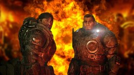 Das Bild zeigt zwei charakteristische Figuren aus dem Gears of War Universum, die in futuristischen Rüstungen gekleidet sind. Im Hintergrund ist eine dramatische, feurige Explosion zu sehen, die eine bedrohliche Atmosphäre erzeugt. Die Protagonisten scheinen sich auf eine herausfordernde Situation vorzubereiten, was die Action und Spannung des Spiels widerspiegelt. Die gesamte Bildkomposition vermittelt ein Gefühl von Intensität und Urgency, passend zum Genre des Spiels.