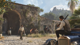 Das Bild zeigt eine Szene aus einem Spiel, das in einer malerischen, historischen Umgebung spielt. Im Vordergrund sitzt eine Person auf einem alten, blauen Auto und hält ein Gewehr. Auf der Straße geht eine andere Person, die mit einem Sack in der Hand unterwegs ist. Im Hintergrund sind Gebäuderuinen und eine üppige, grüne Landschaft zu sehen, die eine ruhige, aber gleichzeitig ansprechende Atmosphäre vermittelt. Der Himmel ist klar und sonnig, was der Szene ein lebendiges Gefühl verleiht. Das Bild zeigt eine Szene aus einem Spiel, das in einer malerischen, historischen Umgebung spielt. Im Vordergrund sitzt eine Person auf einem alten, blauen Auto und hält ein Gewehr. Auf der Straße geht eine andere Person, die mit einem Sack in der Hand unterwegs ist. Im Hintergrund sind Gebäuderuinen und eine üppige, grüne Landschaft zu sehen, die eine ruhige, aber gleichzeitig ansprechende Atmosphäre vermittelt. Der Himmel ist klar und sonnig, was der Szene ein lebendiges Gefühl verleiht.