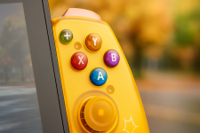 Das Bild zeigt einen modernen Spiele-Controller in auffälligem Design, der an einem Bildschirm oder Tablet angebracht ist. Der Controller ist in leuchtenden Farben gehalten und präsentiert eine Vielzahl von Tasten, die zur Steuerung von Videospielen verwendet werden. Die Tasten sind unterschiedlich gefärbt, sodass eine klare Unterscheidung zwischen den Funktionen möglich ist. Der Hintergrund ist einheitlich blau, was dem Bild eine frische und ansprechende Ausstrahlung verleiht. Insgesamt vermittelt das Bild den Eindruck von innovativer Technologie im Gaming-Bereich.