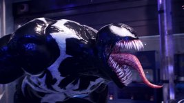 Das Bild zeigt die ikonische Figur Venom, die aus dem Marvel-Universum stammt. Die Kreatur hat eine muskulöse, schwarze Haut mit weißen Flecken und einen bedrohlichen Gesichtsausdruck. Ihr Mund ist weit geöffnet und zeigt eine Vielzahl scharfer Zähne, während ein langer, roter Zungen hervorragt. Die Umgebung wirkt futuristisch mit blauen und weißen Lichtern, was die bedrohliche Präsenz von Venom unterstreicht. Der Kontrast zwischen der dunklen Haut und den hellen Features macht die Figur besonders auffällig. Das Bild zeigt die ikonische Figur Venom, die aus dem Marvel-Universum stammt. Die Kreatur hat eine muskulöse, schwarze Haut mit weißen Flecken und einen bedrohlichen Gesichtsausdruck. Ihr Mund ist weit geöffnet und zeigt eine Vielzahl scharfer Zähne, während ein langer, roter Zungen hervorragt. Die Umgebung wirkt futuristisch mit blauen und weißen Lichtern, was die bedrohliche Präsenz von Venom unterstreicht. Der Kontrast zwischen der dunklen Haut und den hellen Features macht die Figur besonders auffällig.