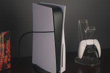 Die PlayStation 5 wird in diesem Bild in einer modernen Umgebung abgebildet. Der Fokus liegt auf der Konsole, die ein schlankes und futuristisches Design aufweist. Sie wird von einem seichten Licht angestrahlt, das ihre akzentuierten Kanten hervorhebt. Im Hintergrund sind Anzeichen von Gaming-Kultur zu sehen, darunter ein Controller, der auf einem benutzerfreundlichen Ständer platziert ist, und grafische Elemente, die das Interesse an Videospielen symbolisieren. Die gesamte Darstellung vermittelt einen Hauch von High-Tech und modernem Gaming-Lifestyle. Die PlayStation 5 wird in diesem Bild in einer modernen Umgebung abgebildet. Der Fokus liegt auf der Konsole, die ein schlankes und futuristisches Design aufweist. Sie wird von einem seichten Licht angestrahlt, das ihre akzentuierten Kanten hervorhebt. Im Hintergrund sind Anzeichen von Gaming-Kultur zu sehen, darunter ein Controller, der auf einem benutzerfreundlichen Ständer platziert ist, und grafische Elemente, die das Interesse an Videospielen symbolisieren. Die gesamte Darstellung vermittelt einen Hauch von High-Tech und modernem Gaming-Lifestyle.